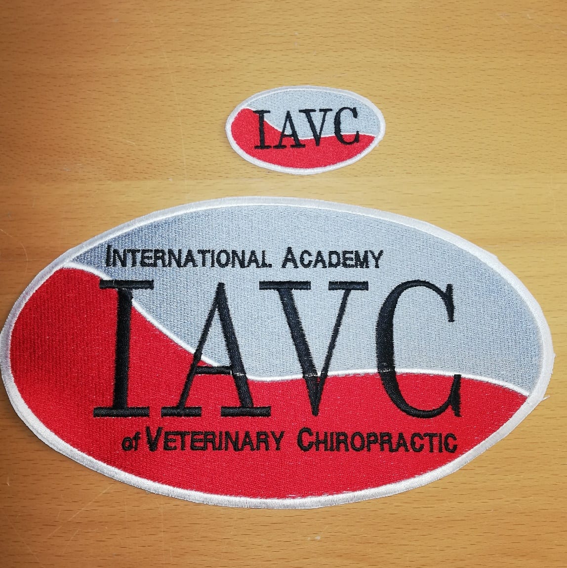Large and small IAVC logo patches shown together